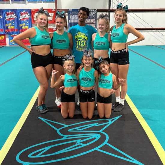Vim Gym Cheerleading Vim Gym all star cheer athletes posing together on the gym floor in San Marcos, TX