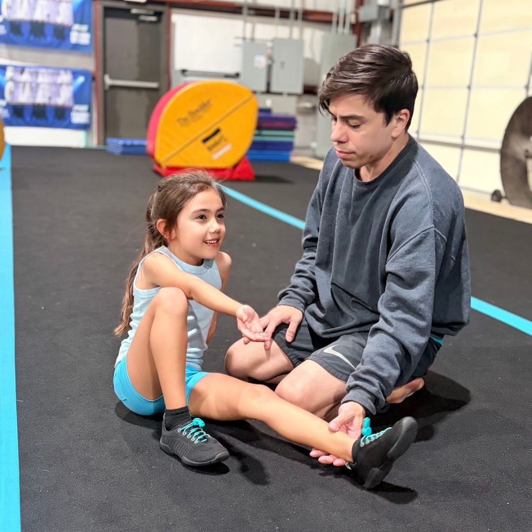 Vim Gym coach working one-on-one with a young athlete on the gym floor